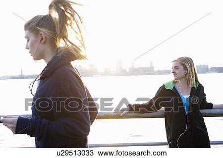 Stock Image - Woman running by the hudson river. Fotosearch
