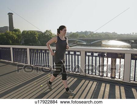 Woman running over bridge View Large Photo Image Picture - Woman running over bridge. Fotosearch