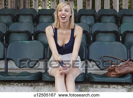 Stock Photo - Woman shouting from the stands. Fotosearch