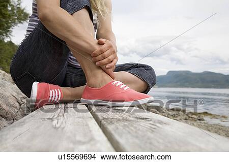 Woman sitting on bench by sea View Large Photo Image Picture - Woman sitting on bench by sea. Fotosearch