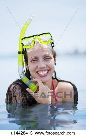 Stock Image - Woman snorkeling at the beach. Fotosearch