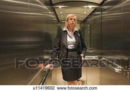 Woman standing in lift View Large Photo Image Stock Image - Woman standing in lift. Fotosearch