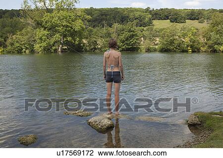 Woman standing on ledge in river View Large Photo Image Stock Image - Woman standing on ledge in river. Fotosearch