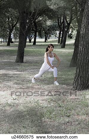 Woman stretching in a park View Large Photo Image Stock Photography - Woman stretching in a park. Fotosearch