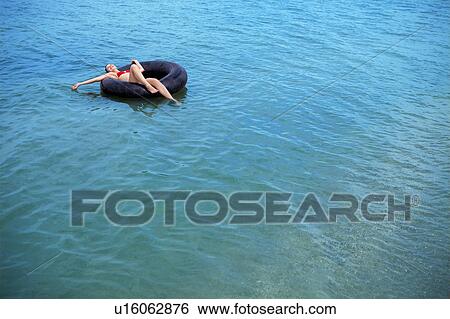 Stock Photograph - Woman swimming at the beach. Fotosearch