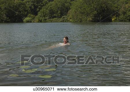 Woman swimming in river View Large Photo Image Stock Image - Woman swimming in river. Fotosearch