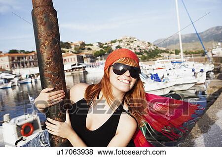 Stock Photo - Woman swinging around pole. Fotosearch