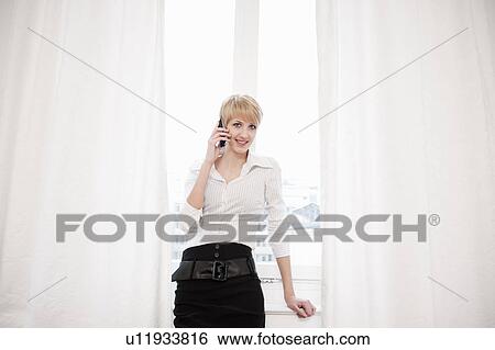 Woman talking on telephone, smiling View Large Photo Image Stock Photograph - Woman talking on telephone, smiling. Fotosearch