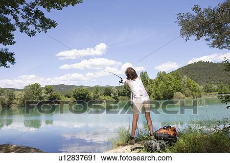 Woman trying to catch a fish View Large Photo Image Stock Image - Woman trying to catch a fish. Fotosearch