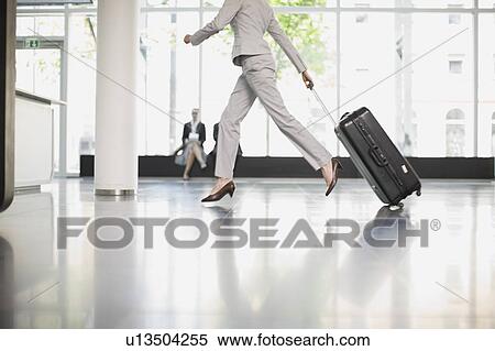 Woman trying to catch her flight View Large Photo Image Stock Photography - Woman trying to catch her flight. Fotosearch
