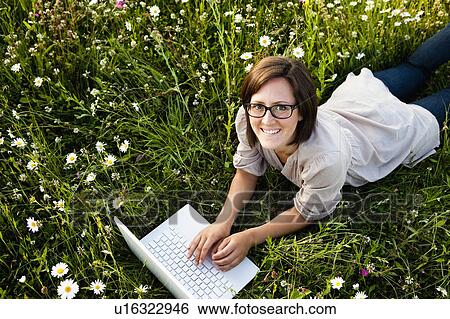 Stock Photograph - Woman typing on laptop. Fotosearch