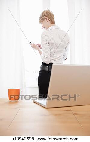 Woman using cellphone, smiling View Large Photo Image Stock Photo - Woman using cellphone, smiling. Fotosearch
