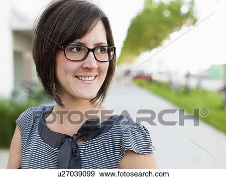 Woman walking down street close up View Large Photo Image Stock Photo - Woman walking down street close up. Fotosearch