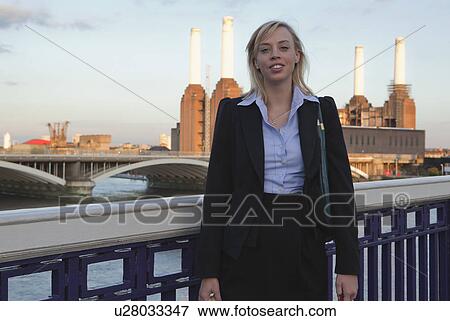 Woman walking home from work over bridge View Large Photo Image Stock Photo - Woman walking home from work over bridge. Fotosearch