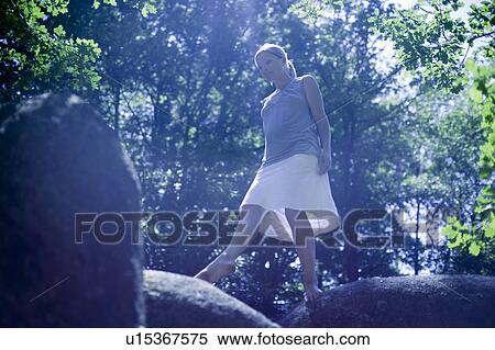 Woman walking on a big roc View Large Photo Image Stock Photography - Woman walking on a big roc. Fotosearch