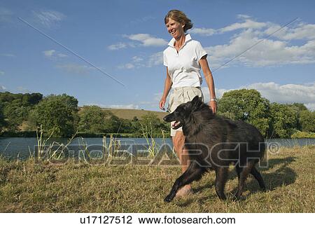 Woman walking with dog View Large Photo Image Stock Image - Woman walking with dog. Fotosearch