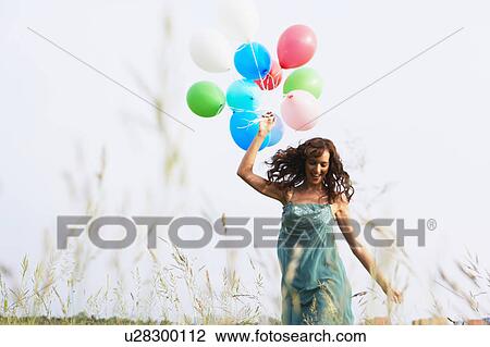 Woman with air balloons walking View Large Photo Image Stock Image - Woman with air balloons walking. Fotosearch