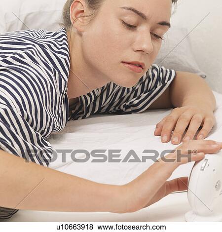 Woman with alarm clock View Large Photo Image Stock Photo - Woman with alarm clock. Fotosearch