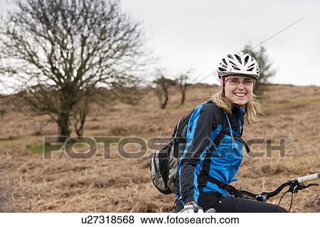 Woman with bike in countryside View Large Photo Image Stock Photo - Woman with bike in countryside. Fotosearch