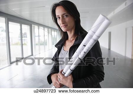 Woman with blue prints, in an empty room View Large Photo Image Stock Image - Woman with blue prints, in an empty room. Fotosearch