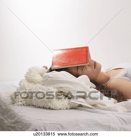 Stock Photography - Woman with book on her head. Fotosearch