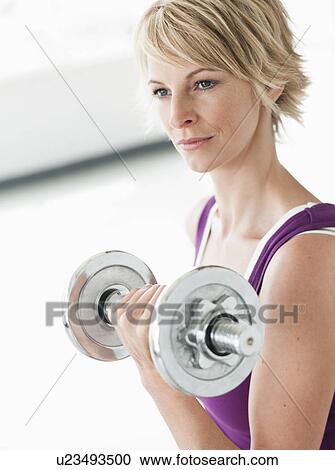 Woman with dumbbell training triceps View Large Photo Image Stock Image - Woman with dumbbell training triceps. Fotosearch