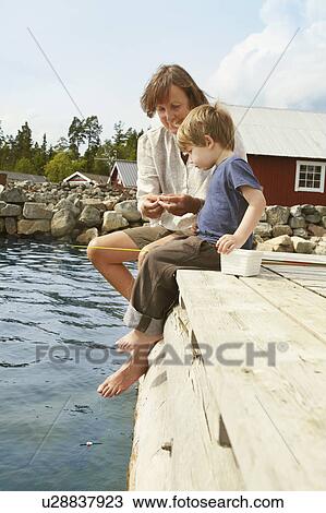 Woman with grandson fishing from jetty View Large Photo Image Stock Image - Woman with grandson fishing from jetty. Fotosearch