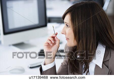 Woman working in office View Large Photo Image Stock Photo - Woman working in office. Fotosearch