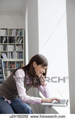 Stock Image - Woman working with laptop. Fotosearch