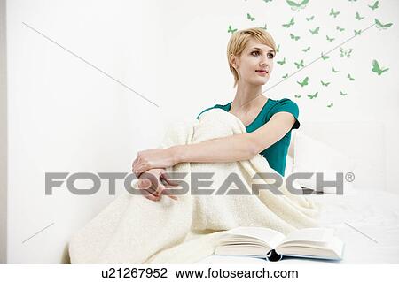 Woman wrapped up on blanket sitting on b View Large Photo Image Stock Image - Woman wrapped up on blanket sitting on b. Fotosearch