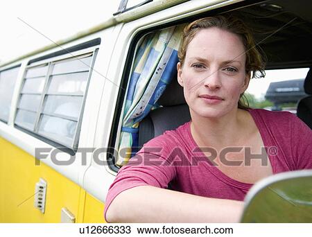 Stock Image - Women at the wheel of a camper van. Fotosearch