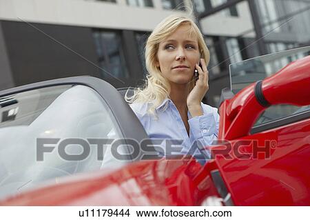 Women on phone in her electric car View Large Photo Image Picture - Women on phone in her electric car. Fotosearch