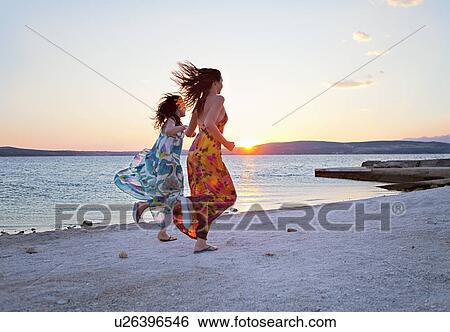 Women running at the beach View Large Photo Image Stock Photograph - Women running at the beach. Fotosearch