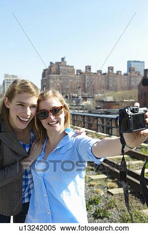 Women taking a picture of themselves View Large Photo Image Stock Photography - Women taking a picture of themselves. Fotosearch