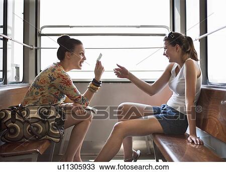 Stock Image - Women travelling in funicular train. Fotosearch