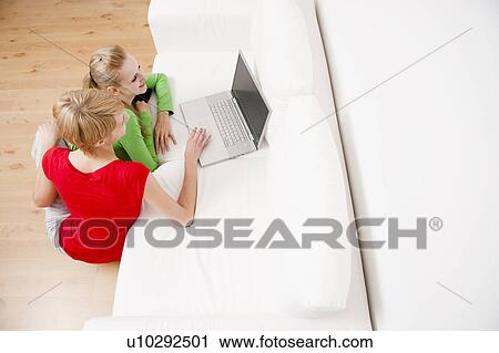 Women using laptop on sofa View Large Photo Image Stock Image - Women using laptop on sofa. Fotosearch