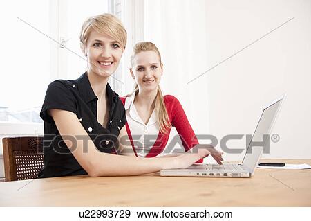 Stock Photo - Women using laptop. Fotosearch