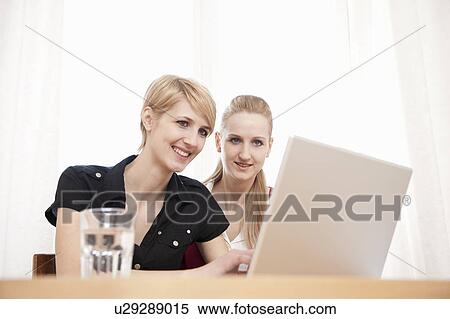 Stock Photography - Women using laptop. Fotosearch