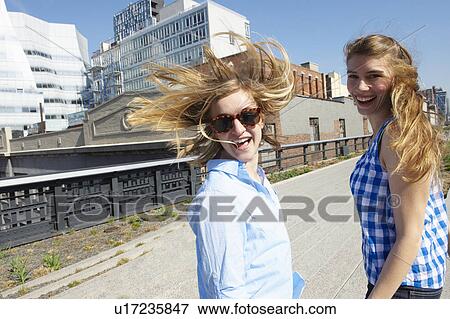 Women walking, wind in their hair View Large Photo Image Stock Photo - Women walking, wind in their hair. Fotosearch