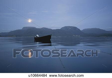 Wooden boat on calm sea at night View Large Photo Image Picture - Wooden boat on calm sea at night. Fotosearch