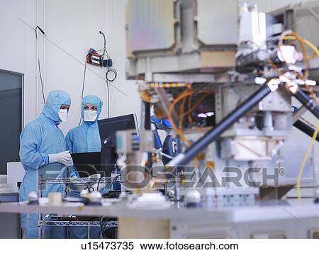 Stock Photography - Worker building satellite dish. Fotosearch