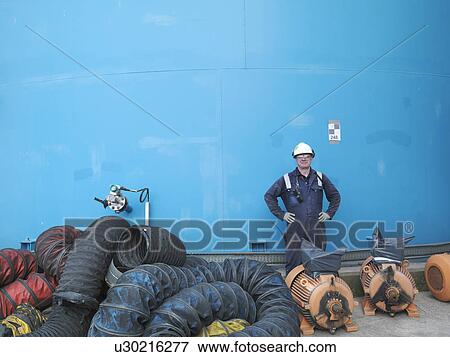 Stock Photo - Worker in coal fired power station. Fotosearch