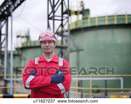 Worker in front of oil tank View Large Photo Image Stock Photo - Worker in front of oil tank. Fotosearch