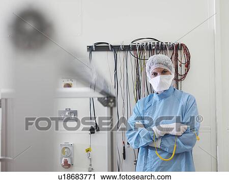 Stock Image - Worker in satellite testing station. Fotosearch