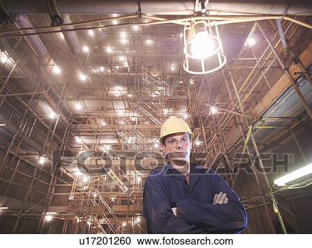 Stock Image - Worker posing inside of a furnace. Fotosearch