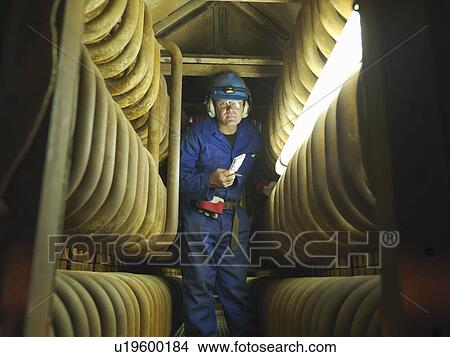 Worker repairing a furnace View Large Photo Image Picture - Worker repairing a furnace. Fotosearch