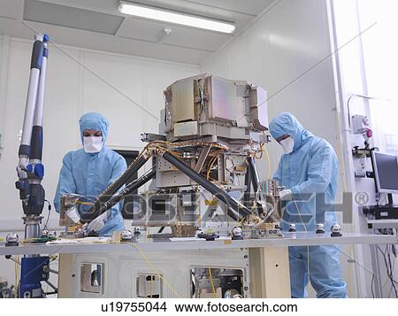 Workers assembling satellite dish View Large Photo Image Picture - Workers assembling satellite dish. Fotosearch