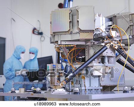 Stock Image - Workers building satellite dish. Fotosearch