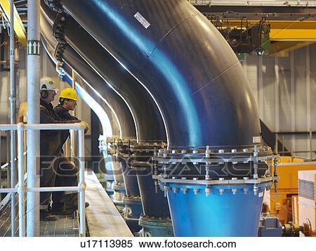 Stock Photography - Workers checking cooling water pipes. Fotosearch