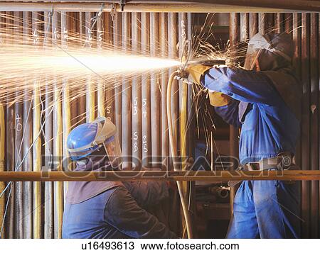 Workers cutting in a power station View Large Photo Image Stock Image - Workers cutting in a power station. Fotosearch